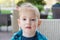 Portrait of a cute little boy in the cafe in spring