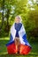 Portrait of cute little boy in public summer park with russian flag on background. Fans child supporting and cheering their