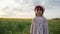 Portrait of cute little girl, background flower field, female child in panama, hat on head, kid looking at camera, happy