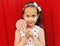 Portrait of cute little girl child with lollipop wearing a dress