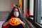 Portrait of cute Little Girl in costume of evil at home. Happy Halloween during coronavirus covid-19 pandemic quarantine concept.