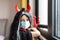 Portrait of cute Little Girl in costume of evil at home. Happy Halloween during coronavirus covid-19 pandemic quarantine concept.