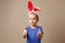 Portrait of a cute little girl dressed in Easter bunny ears shows gesture perfectly