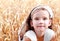 Portrait of cute little girl on field of wheat