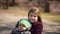 Portrait of cute little girl and her older beautiful sister on playground