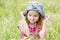 Portrait of a cute little girl on the meadow