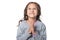 Portrait of cute little girl posing and praying against white