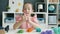 Portrait of cute little girl recording video about playdough then showing thumbs-up and waving hand blogging