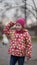 Portrait of cute little girl in red hat on playground