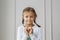 Portrait of cute little girl showing hand heart gesture, sweet precious child making body language, love, positive feeling and