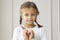 Portrait of cute little girl showing hand heart gesture, sweet precious child making body language, love, positive feeling and