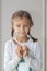 Portrait of cute little girl showing hand heart gesture, sweet precious child making body language, love, positive feeling and