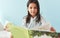 Portrait of a cute little girl sitting in the bed and reading the fairy tale book. Happy child in pajamas reading interesting