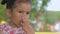 Portrait of a cute little girl who eats black currant.