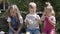 Portrait of Cute Little Three Children sitting on the beanch Garden. Cheerful Carefree Childhood. Preschool Siblings