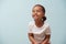 Portrait of cute mulatto little girl dressed for sport. Pale blue background