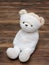 Portrait of cute mummy teddy bear doll bind with white gauze or bandage on dark wooden background