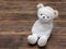 Portrait of cute mummy teddy bear doll bind with white gauze or bandage on dark wooden background