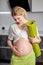 Portrait Of Cute Pregnant Female Stroking Touching Belly, Mom-to-be Expecting Baby, Stand With Fitness Mat After Yoga