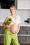 Portrait Of Cute Pregnant Female Stroking Touching Belly, Mom-to-be Expecting Baby, Stand With Fitness Mat After Yoga