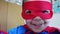 Portrait of cute preschooler kid with red superhero mask over his eyes