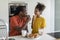 Portrait Of Cute Preteen Black Girl Eating Snacks With Dad In Kitchen
