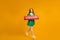 Portrait of cute redhead woman in green dress jumping, holding subscribe sign, ask appreciation