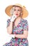 Portrait of cute retro blond wearing sun hat, seated, isolated o