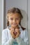 Portrait of cute showing hand heart gesture, sweet precious child making body language, love, positive feeling and emotion