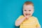 Portrait of cute shy blond little toddler boy in T-shirt