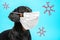 Portrait of a cute sick Dachshund dog, black and tan, wearing white medical mask on a muzzle on a blue background, with schematica