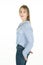 Portrait of cute slim blonde young happy woman smiling on white background blue jeans clothes shirt