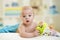 Portrait of cute smiling baby lying on bed after having bathtime