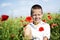 Portrait of cute smiling boy in poppy field
