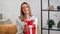 Portrait cute smiling lady opening festive red gift box posing rejoicing. Shot with RED camera in 4K