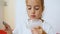 portrait of a cute teenage girl eating cream ice cream holding a glass ice cream maker on her leg and a silver metal