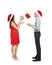 Portrait of cute young couple catching falling Christmas gifts on white background