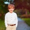 Portrait of cute young fashionable boy posing outdoors