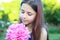 Portrait of a cute young teen girl with a peony close to her face