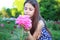 Portrait of a cute young teen girl with a peony close to her face