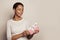 Portrait of cute youth holding gift with white silky ribbon on white background