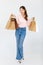 Portrait  cutout studio full body shot of Asian cheerful female clients customers shoppers in casual outfit buying holding