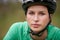 Portrait, cycling and helmet with woman closeup in nature for fitness, training or off road hobby. Face, exercise and