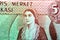 A portrait of a Cypriot woman wearing national dress from the obverse side of Cyprus 50 fifty cents banknote currency