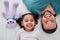 Portrait of dad, child and teddy bear on bed from above, bonding and love with play time to relax. Smile, happiness and