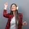 Portrait of dancing urban woman with headphones against gray background