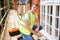 Portrait Of Decorator On Scaffolding Painting House Windows