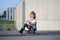 A portrait of defiant boy with skateboard outdoors.