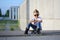 A portrait of defiant boy with skateboard outdoors.