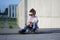 A portrait of defiant boy with skateboard outdoors.